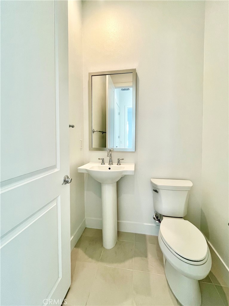 27557 Elderberry Drive Valencia, CA 91381 - Photo 11 of 39 a bathroom with a sink a toilet and mirror