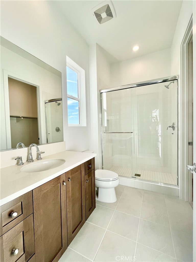 27557 Elderberry Drive Valencia, CA 91381 - Photo 13 of 39 a bathroom with a shower sink vanity and toilet