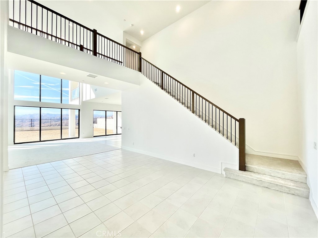 27557 Elderberry Drive Valencia, CA 91381 - Photo 14 of 39 a view of staircase with white walls and a window