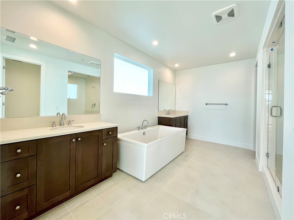 27557 Elderberry Drive Valencia, CA 91381 - Photo 24 of 39 a bathroom with a double vanity sink mirror and bathtub