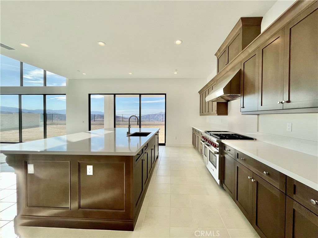 27557 Elderberry Drive Valencia, CA 91381 - Photo 6 of 39 a kitchen with stainless steel appliances granite countertop a stove and a sink