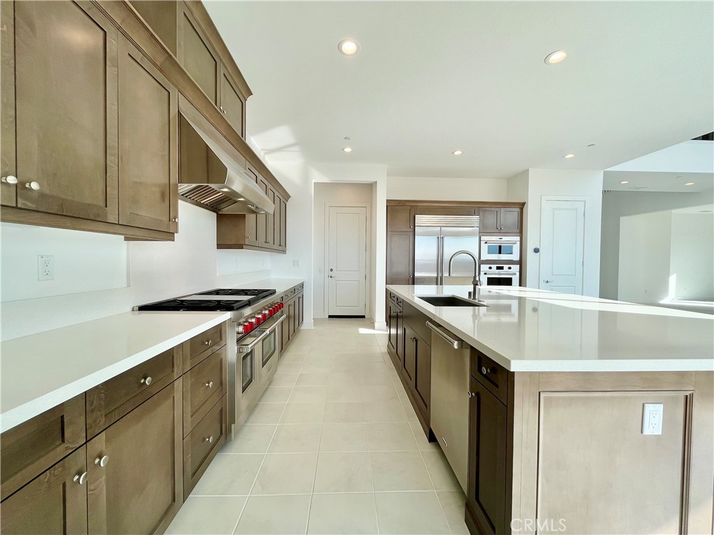 27557 Elderberry Drive Valencia, CA 91381 - Photo 7 of 39 a large kitchen with stainless steel appliances granite countertop a lot of counter space and a sink