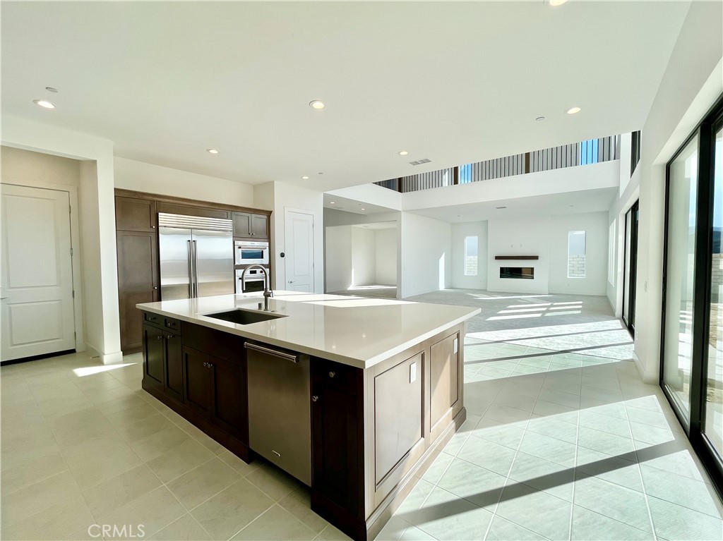 27557 Elderberry Drive Valencia, CA 91381 - Photo 8 of 39 a kitchen with stainless steel appliances granite countertop a sink and a refrigerator