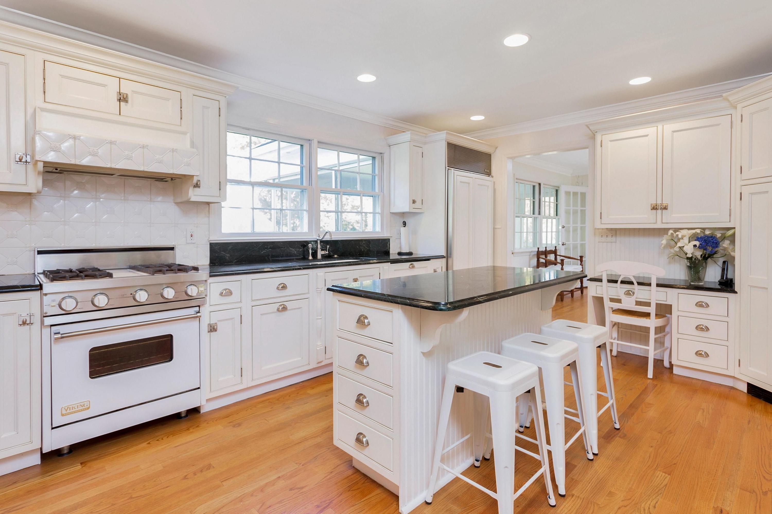 451 Middlesex Road Darien, CT 06820 - Photo 11 of 40 a kitchen with granite countertop white cabinets and white appliances