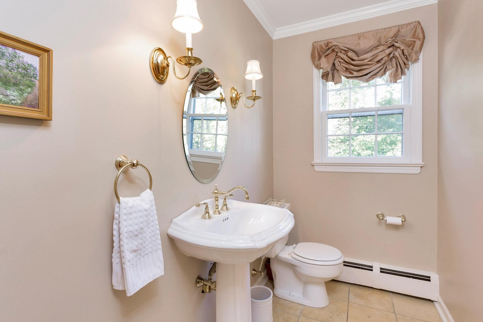 451 Middlesex Road Darien, CT 06820 - Photo 17 of 40 a bathroom with a toilet sink and mirror