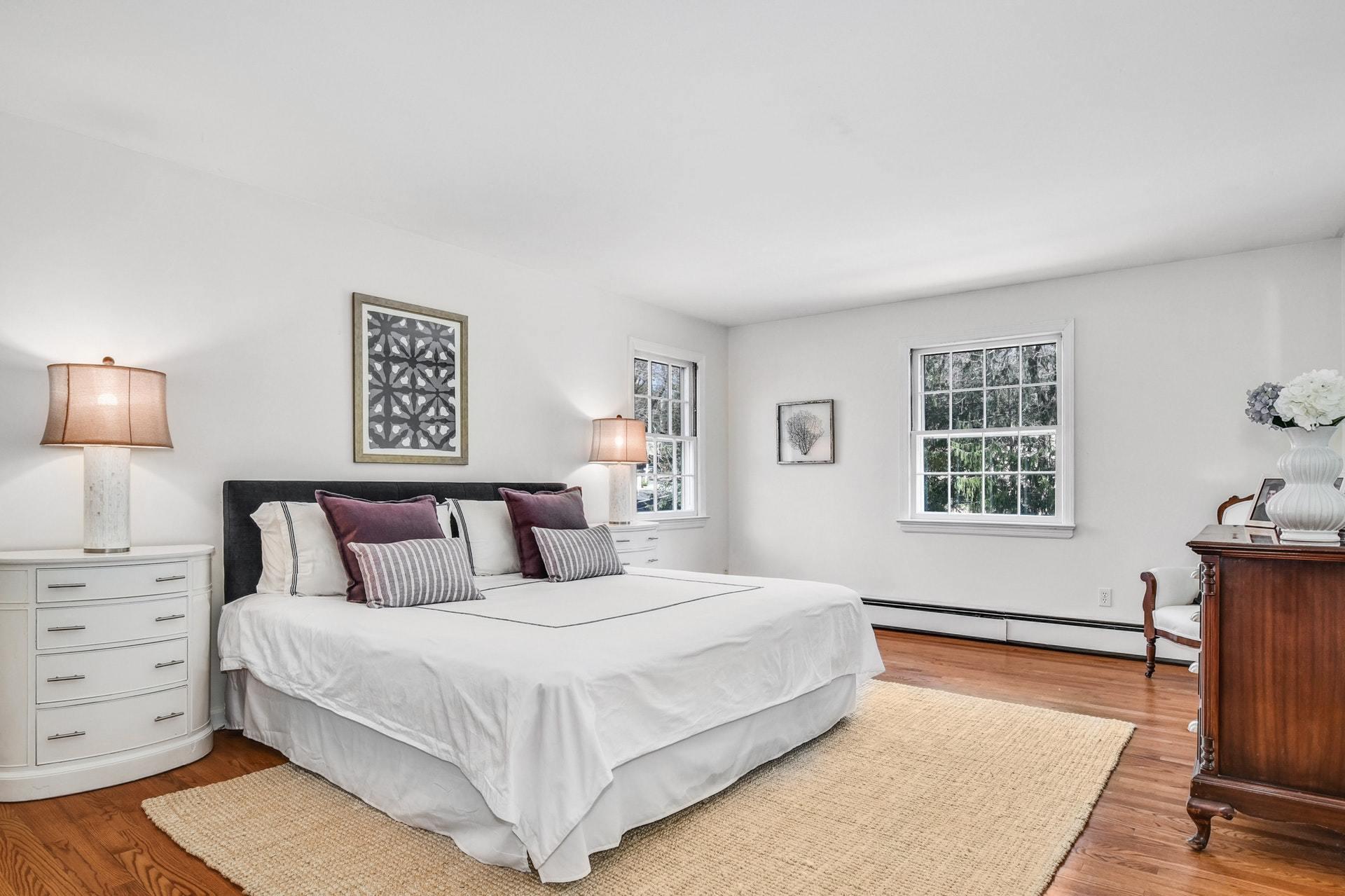 451 Middlesex Road Darien, CT 06820 - Photo 18 of 40 a bedroom with a bed and a dresser