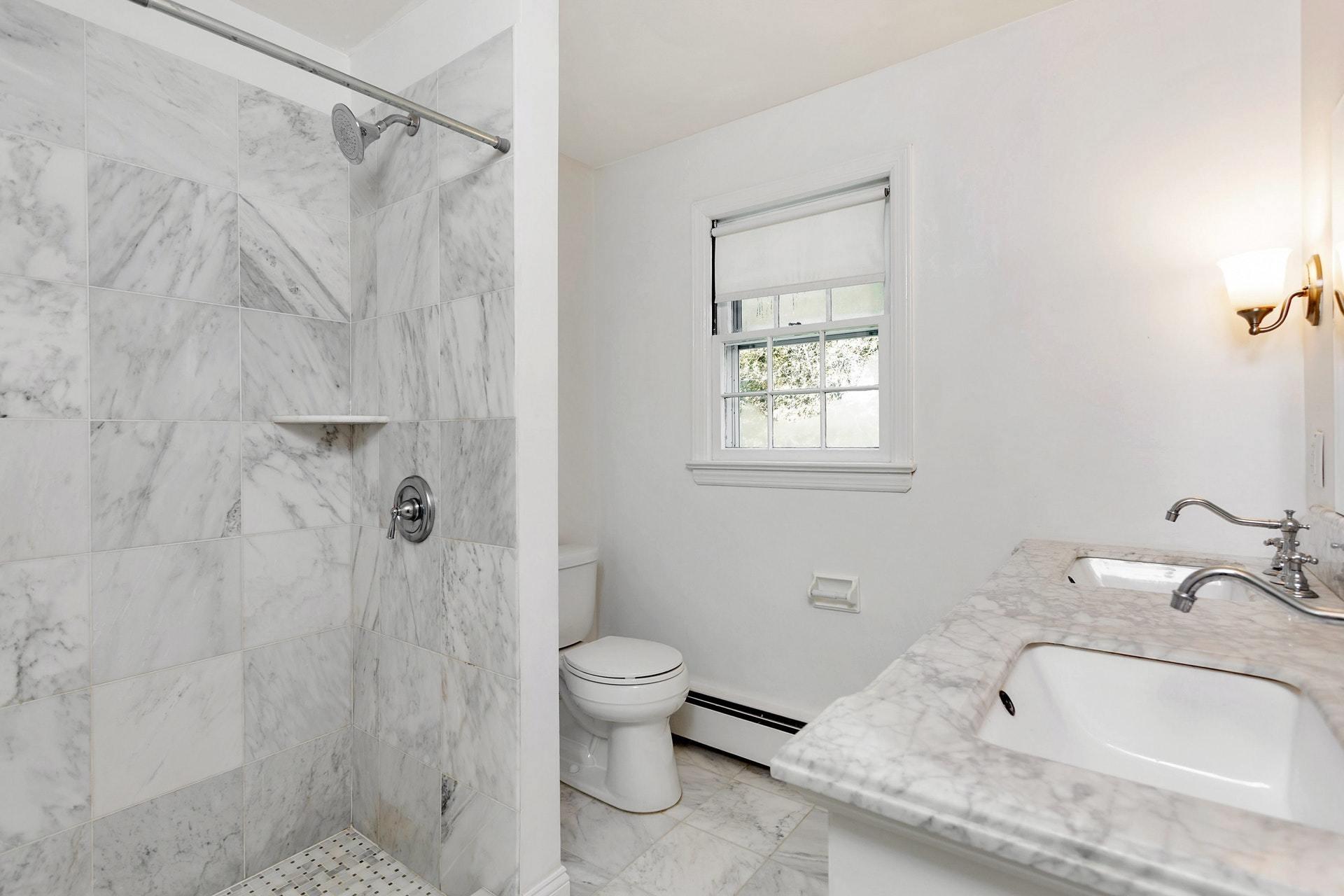 451 Middlesex Road Darien, CT 06820 - Photo 19 of 40 a bathroom with a granite countertop sink toilet and shower