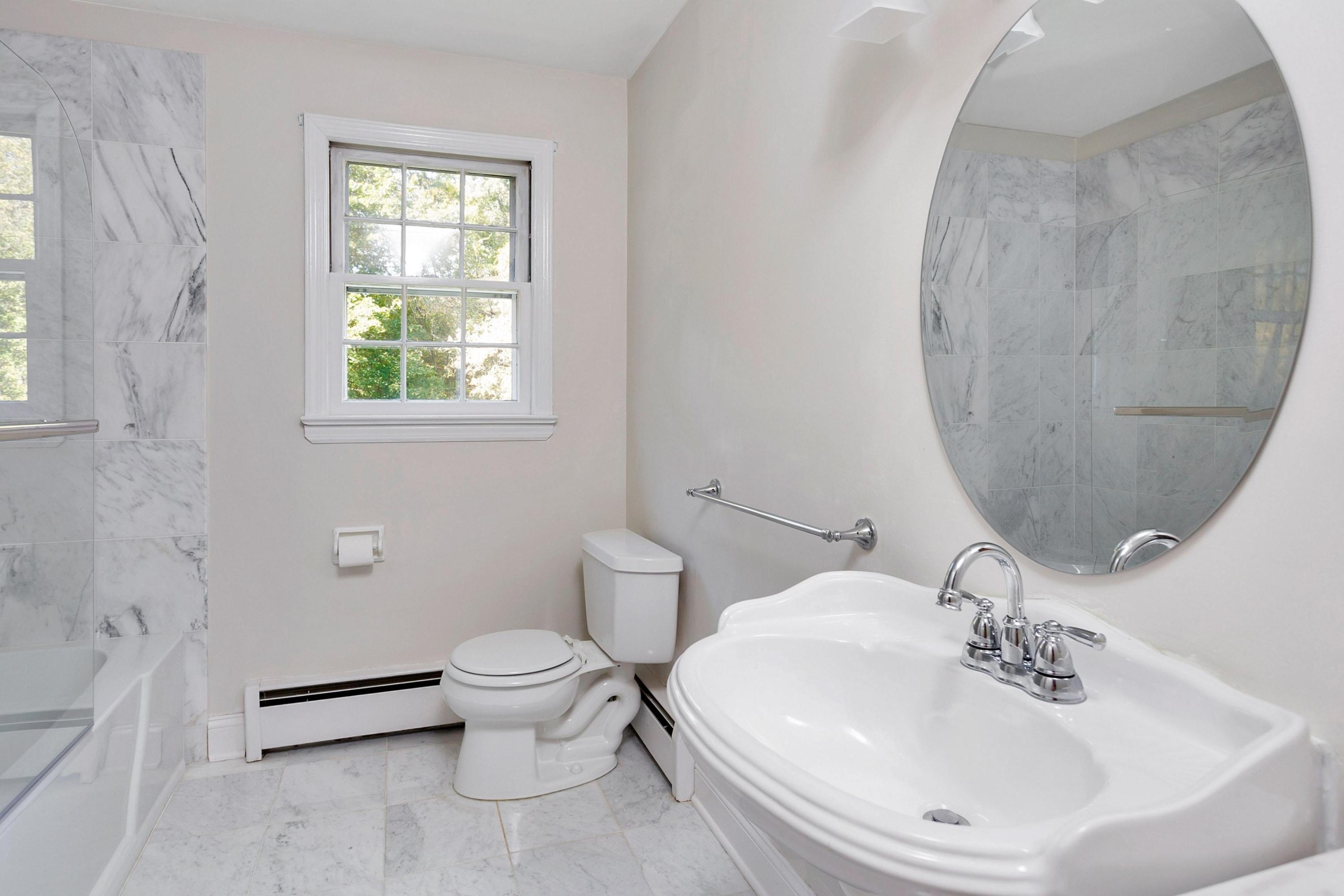 451 Middlesex Road Darien, CT 06820 - Photo 21 of 40 a bathroom with a sink a toilet and a mirror