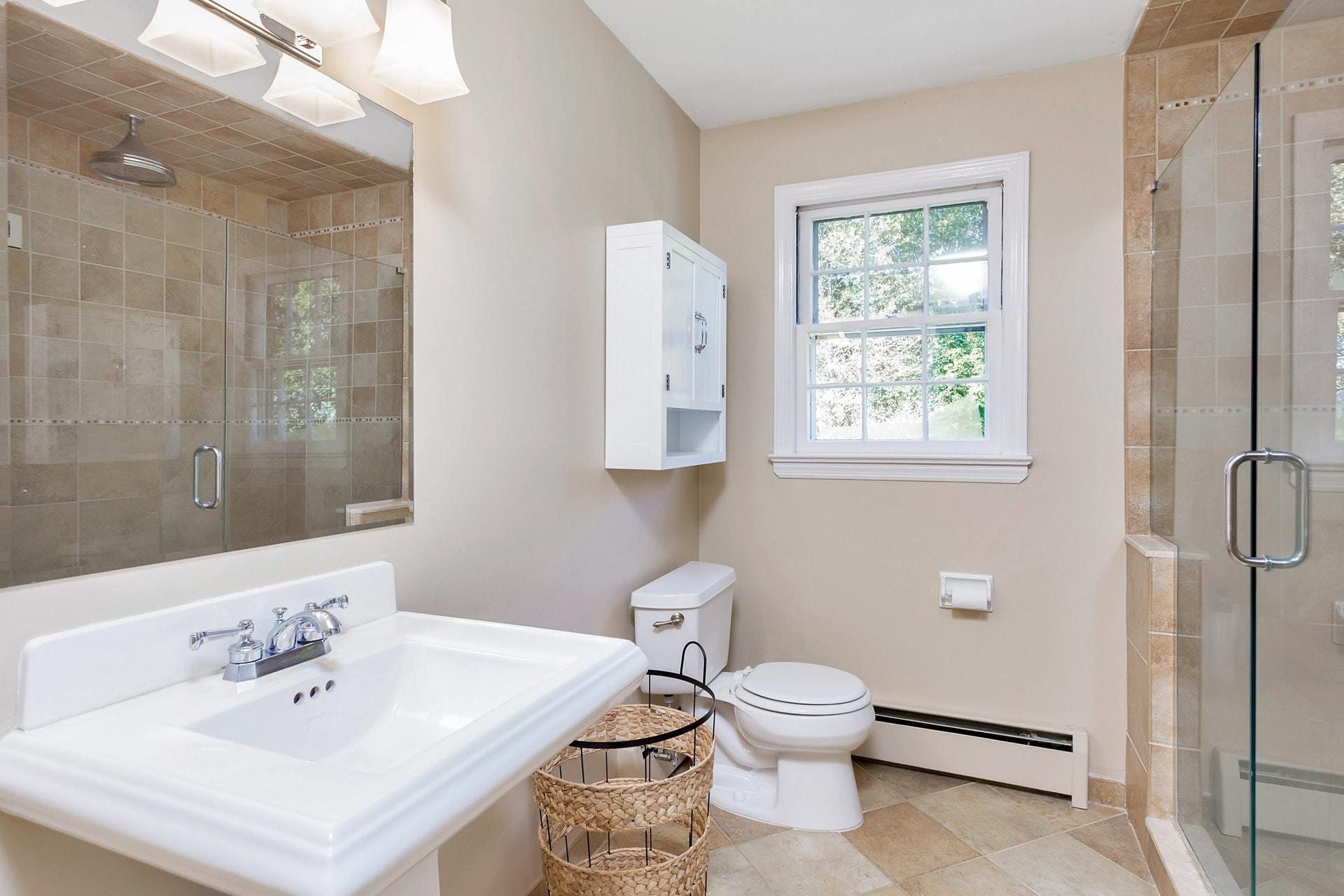 451 Middlesex Road Darien, CT 06820 - Photo 24 of 40 a bathroom with a toilet a sink and mirror