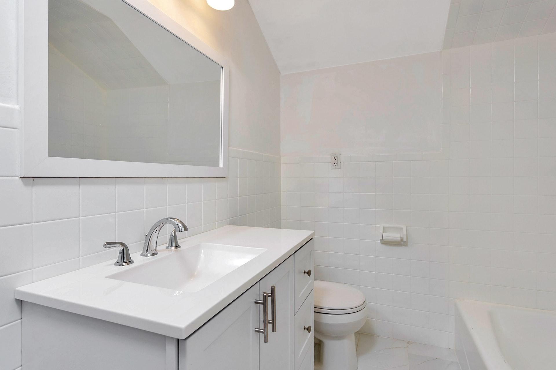 451 Middlesex Road Darien, CT 06820 - Photo 27 of 40 a bathroom with a sink a toilet and mirror