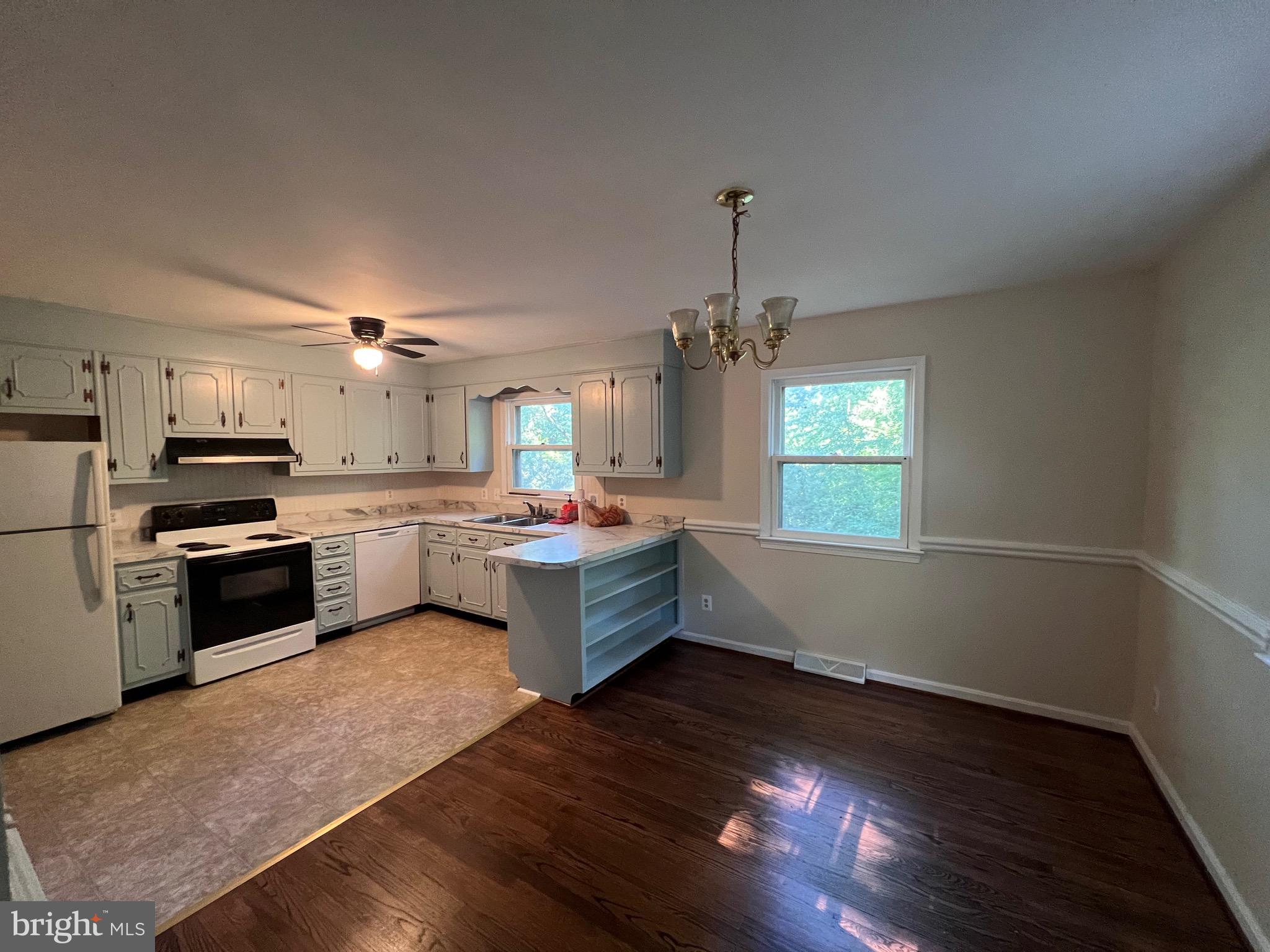 439 Ridgemore Street Fredericksburg, VA 22405 - Photo 17 of 17 a large kitchen with cabinets wooden floor and stainless steel appliances
