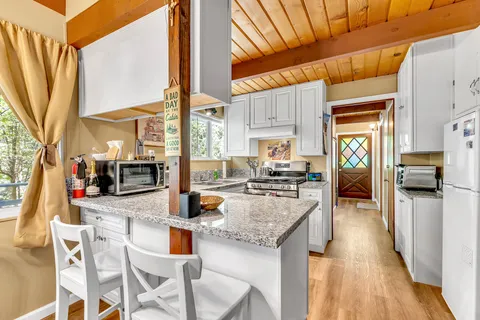a kitchen with stainless steel appliances granite countertop a stove and more cabinets