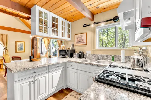 a kitchen with stainless steel appliances granite countertop a stove and a sink