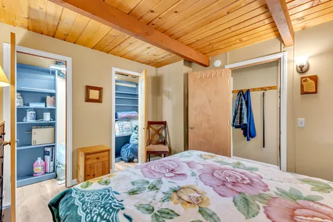 a bedroom with a bed and a dresser