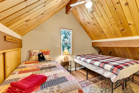 a bedroom with two beds and a window