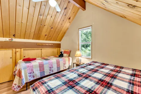 a bedroom with a bed a table and chair