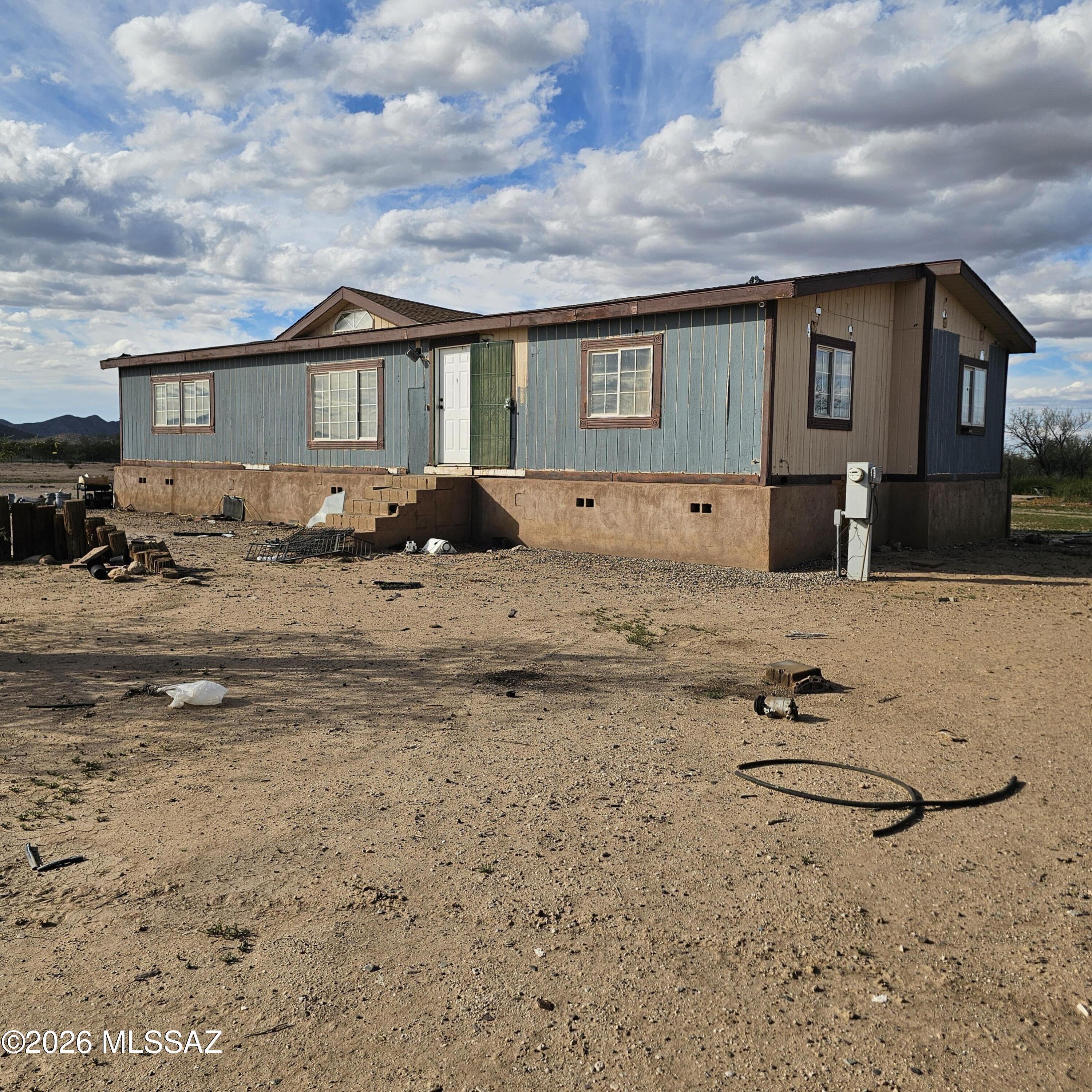 14020 West Park Road Tucson, AZ 85735 - Photo 1 of 18 a front view of a house with a yard