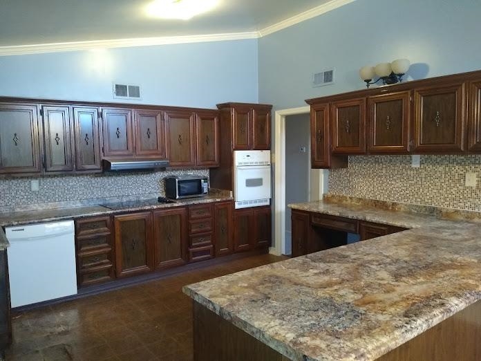 1435 East Holmes Road Memphis, TN 38116 - Photo 5 of 25 a kitchen with kitchen island granite countertop a sink stove and refrigerator
