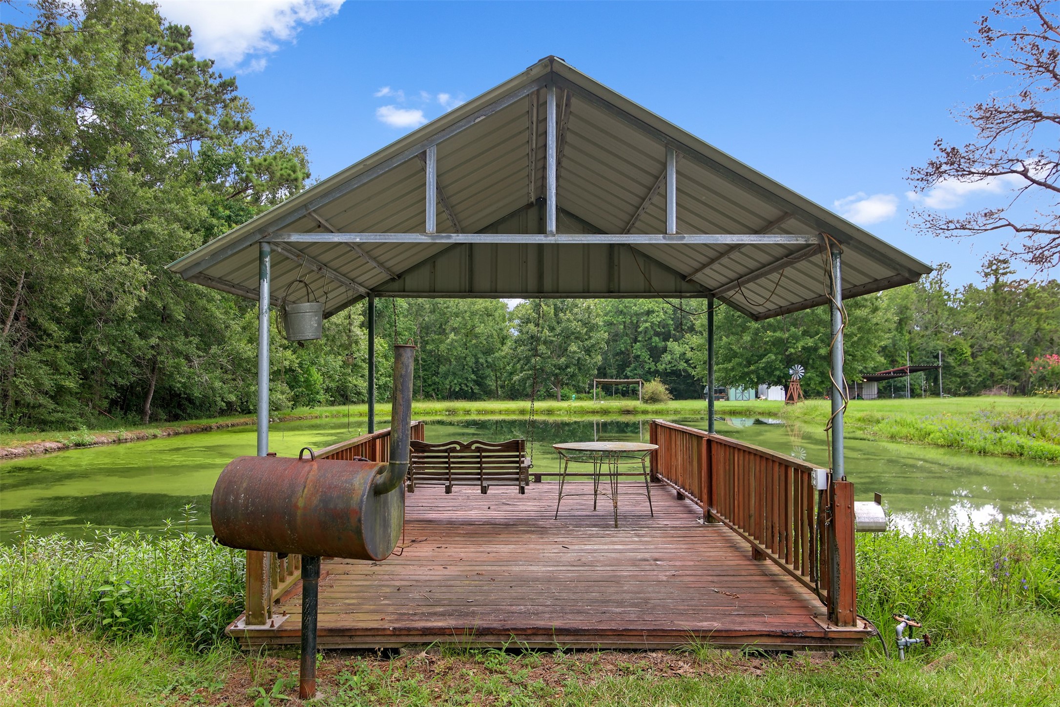 11692 Clark Lane Conroe, TX 77385 - Photo 24 of 35 Relaxing is a breeze with a pavilion area right off the pond. This is perfect for eating, entertaining or just swinging by the sunset.