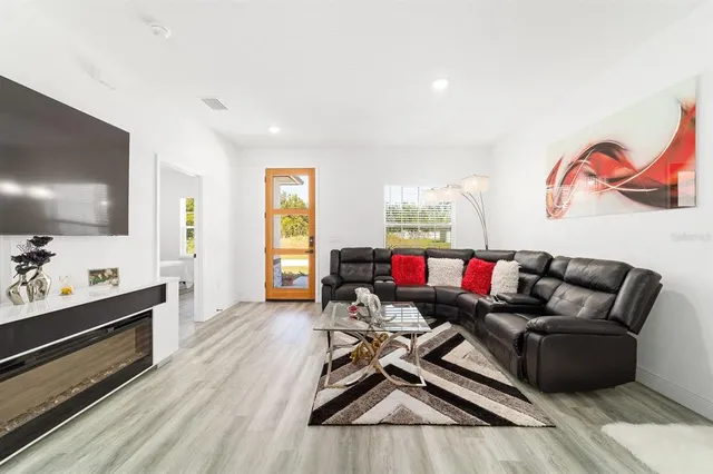 a living room with furniture and a flat screen tv
