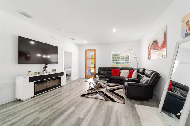 a living room with furniture and a wooden floor