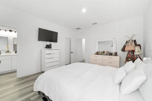 a bedroom with a bed and a table