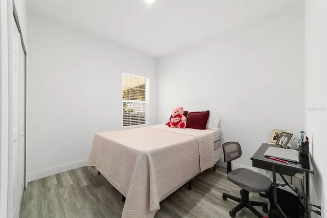 a bed room with a bed and a window