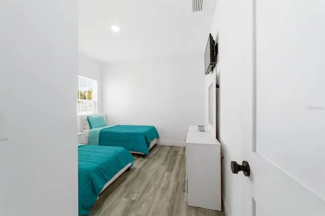 a dining room with furniture and a floor to ceiling window