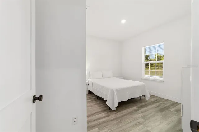 a dining room with furniture and a floor to ceiling window