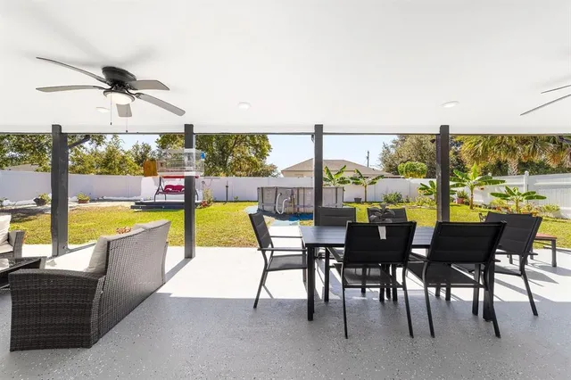 a view of a swimming pool with a yard and seating area