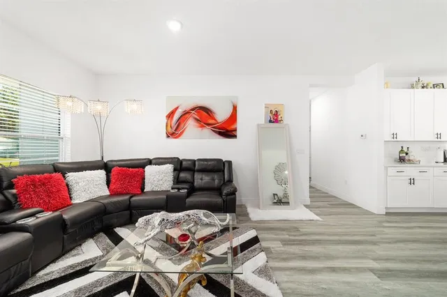 a living room with furniture and wooden floor