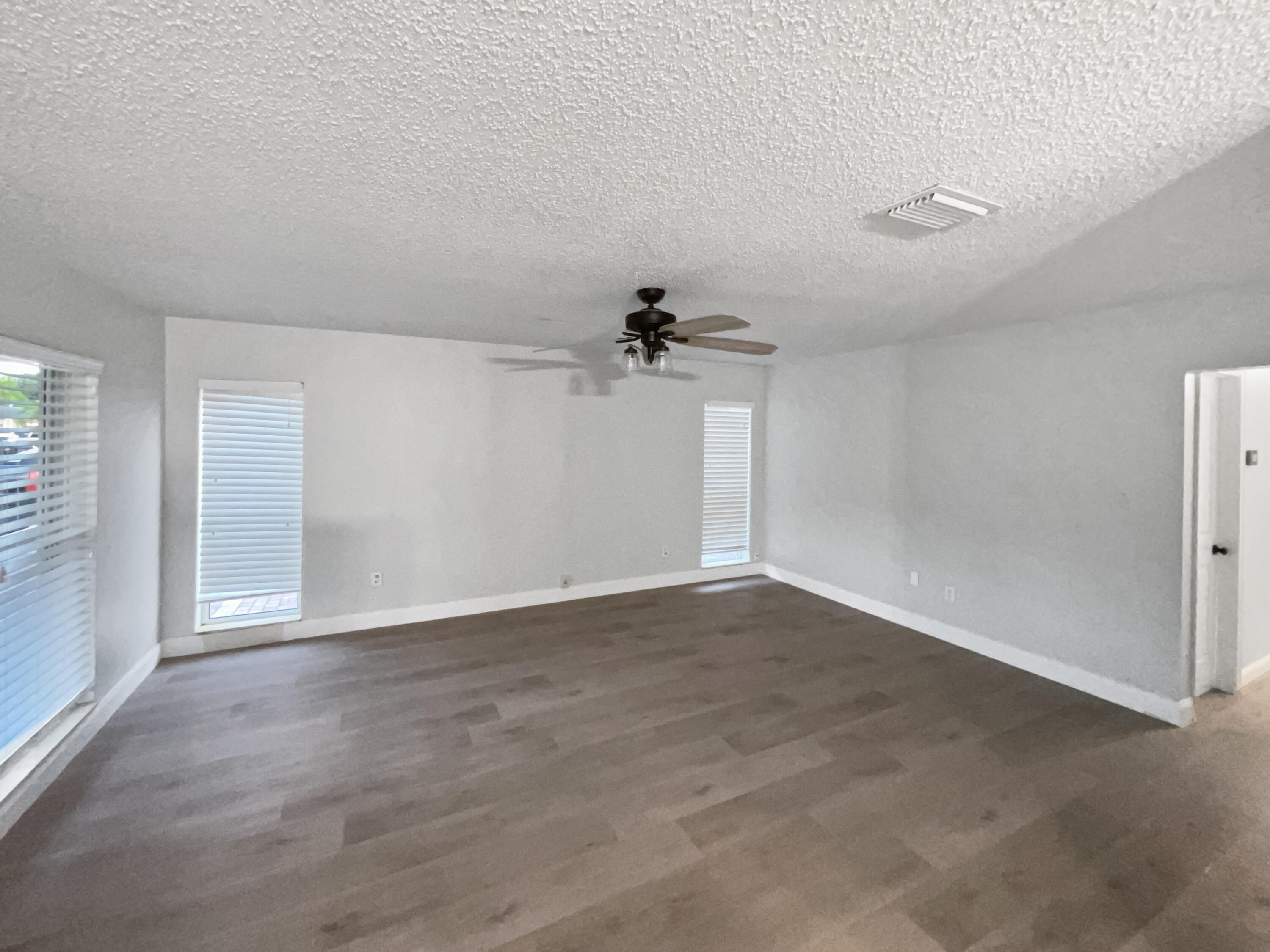 22226 Southwest 65th Terrace Boca Raton, FL 33428 - Photo 12 of 27 an empty room with a empty space and a ceiling fan