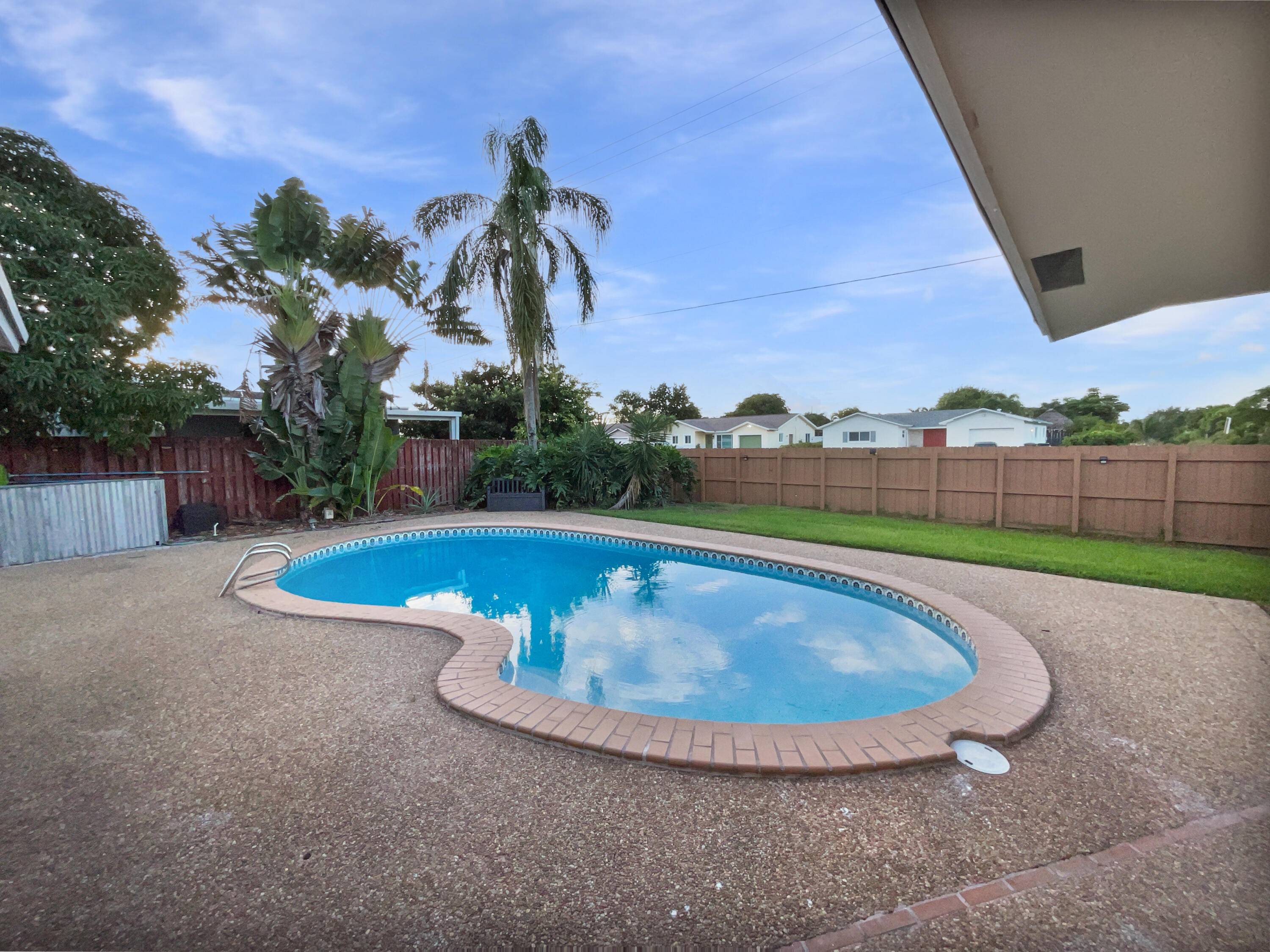 22226 Southwest 65th Terrace Boca Raton, FL 33428 - Photo 16 of 27 a view of a swimming pool with a yard