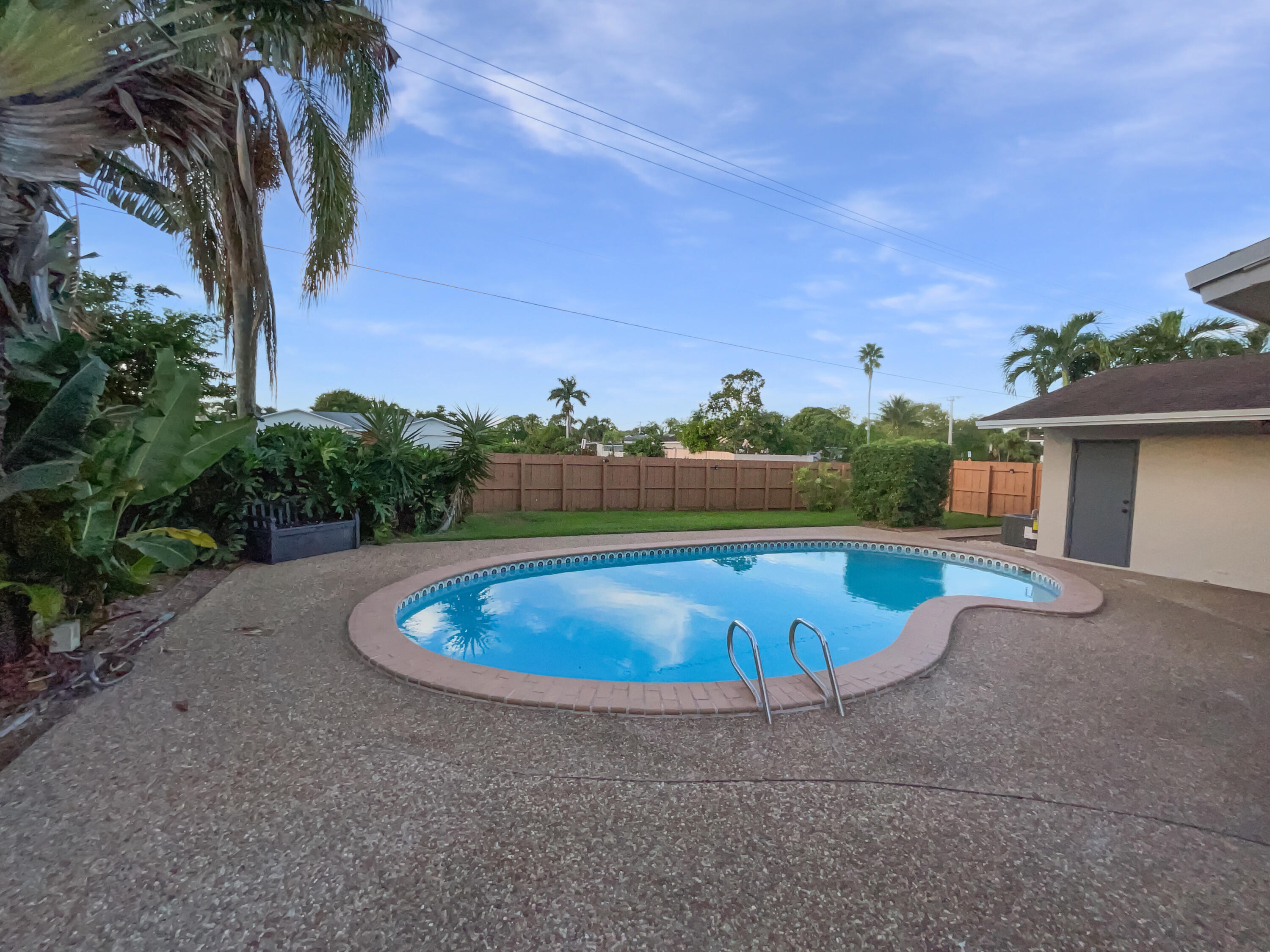 22226 Southwest 65th Terrace Boca Raton, FL 33428 - Photo 18 of 27 a view of a swimming pool with a yard