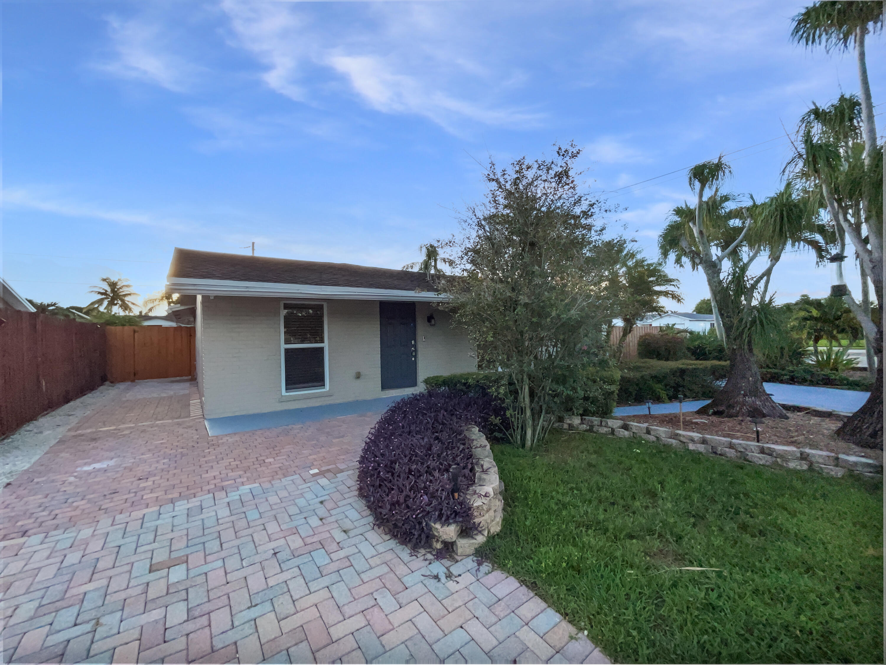 22226 Southwest 65th Terrace Boca Raton, FL 33428 - Photo 9 of 27 a view of a house with a yard and potted plants