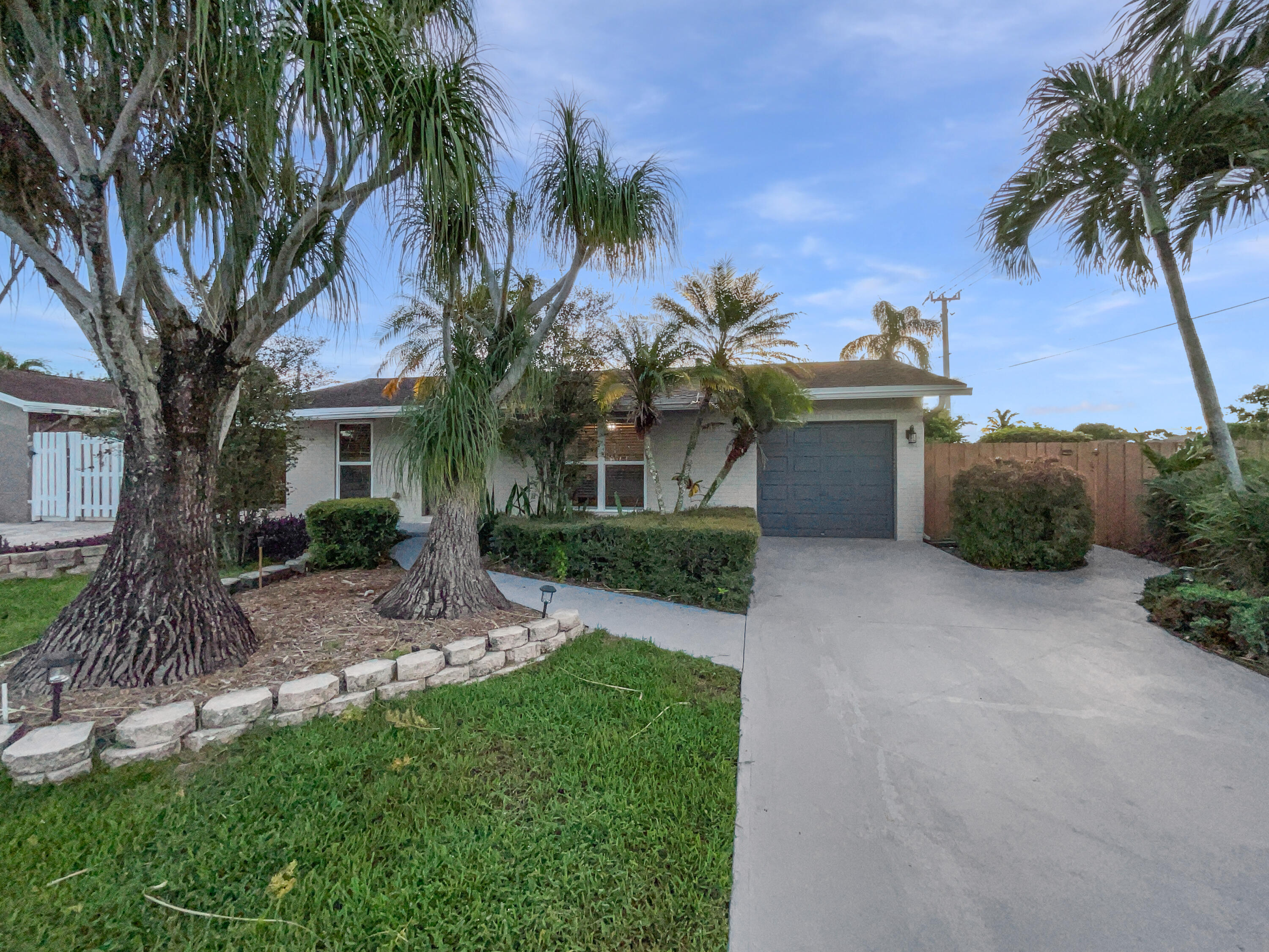 22226 Southwest 65th Terrace Boca Raton, FL 33428 - Photo 10 of 27 a front view of a house with a garden