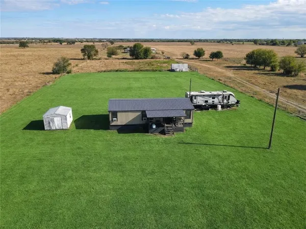 a view of a house with a yard and lake view