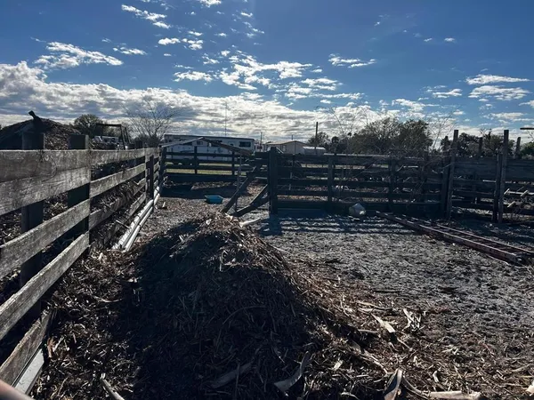 a view of a street with cars parked on the roadside