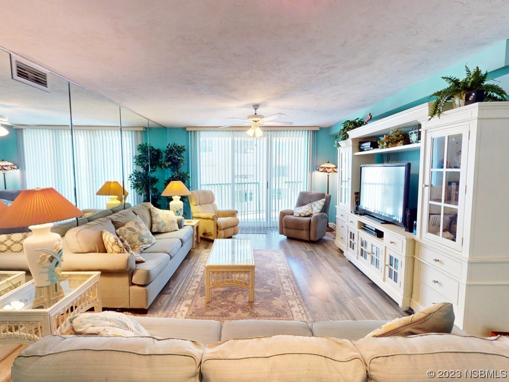 4555 South Atlantic Avenue, Unit 4502 Ponce Inlet, FL 32127 - Photo 15 of 54 a living room with furniture and a flat screen tv