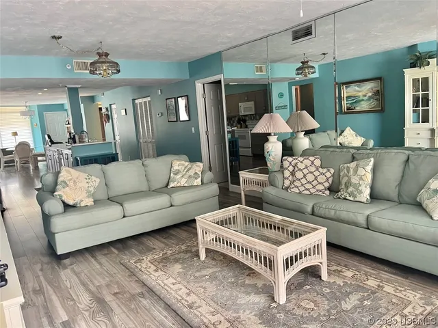 a living room with furniture and a chandelier