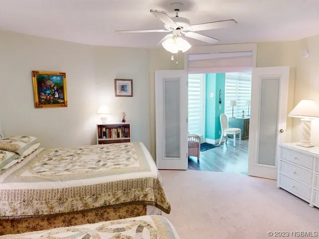 a bedroom with a large bed and a chandelier