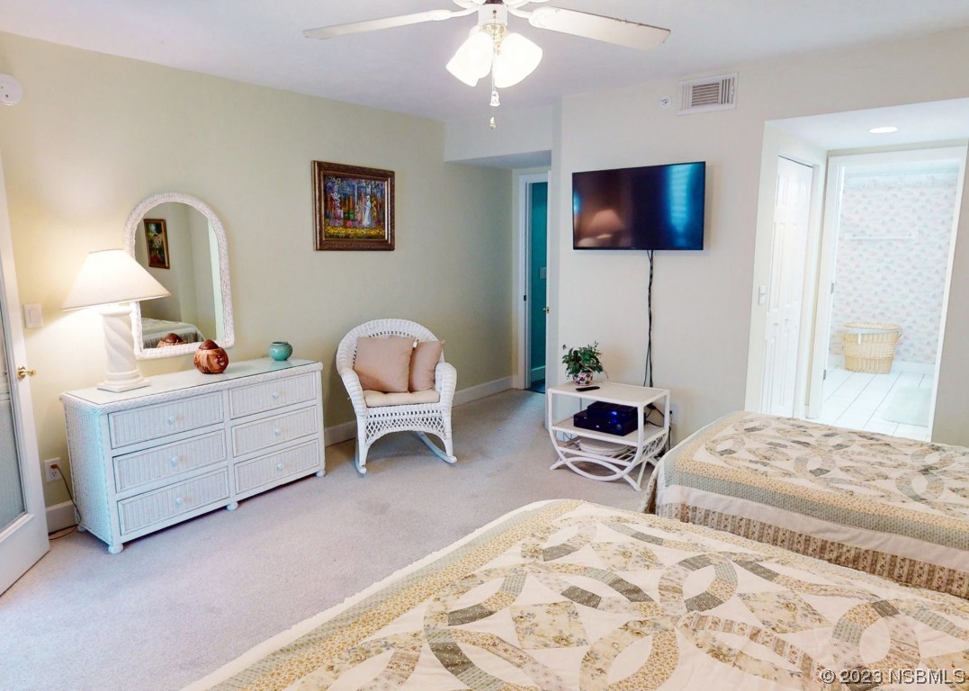 4555 South Atlantic Avenue, Unit 4502 Ponce Inlet, FL 32127 - Photo 22 of 54 a bedroom with a bed and a chandelier