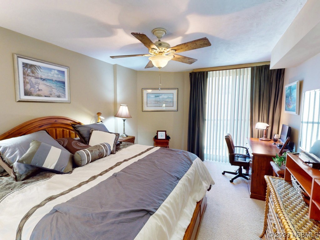 4555 South Atlantic Avenue, Unit 4502 Ponce Inlet, FL 32127 - Photo 24 of 54 a bedroom with a bed and a large mirror