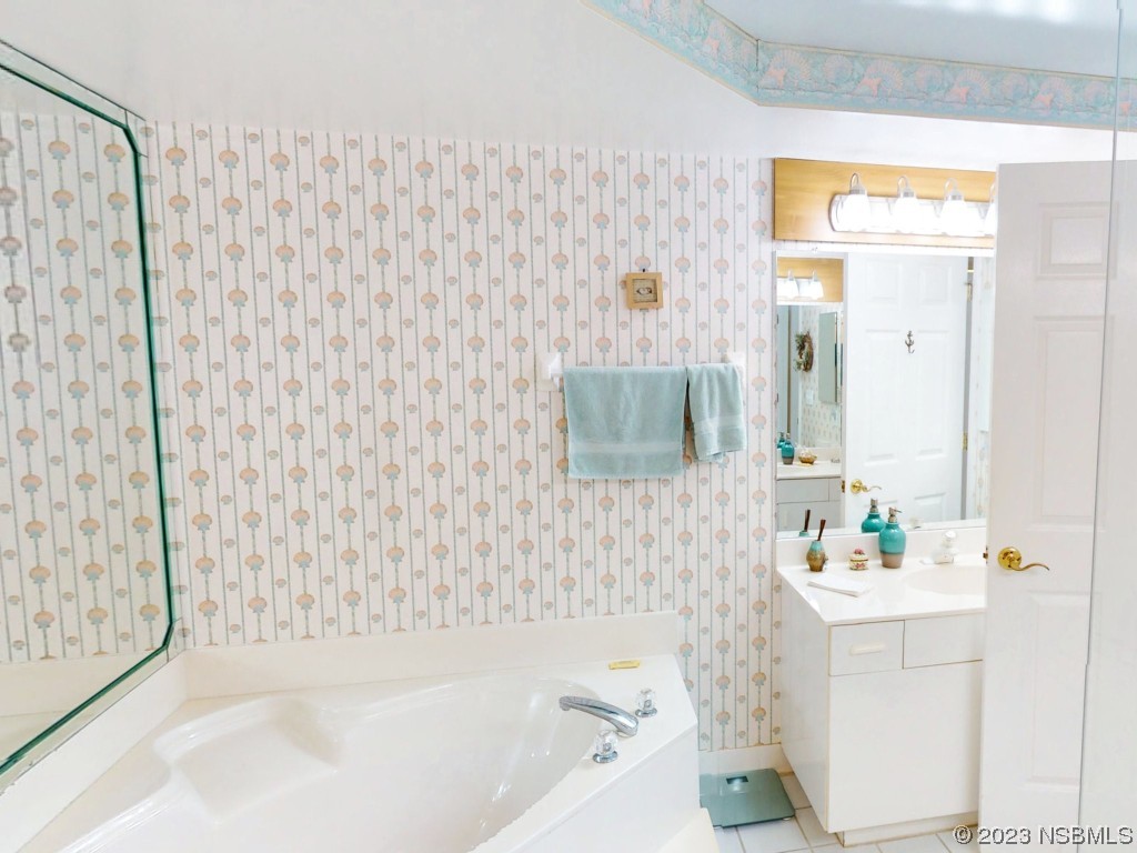 4555 South Atlantic Avenue, Unit 4502 Ponce Inlet, FL 32127 - Photo 30 of 54 a bathroom with a bathtub sink vanity and toilet