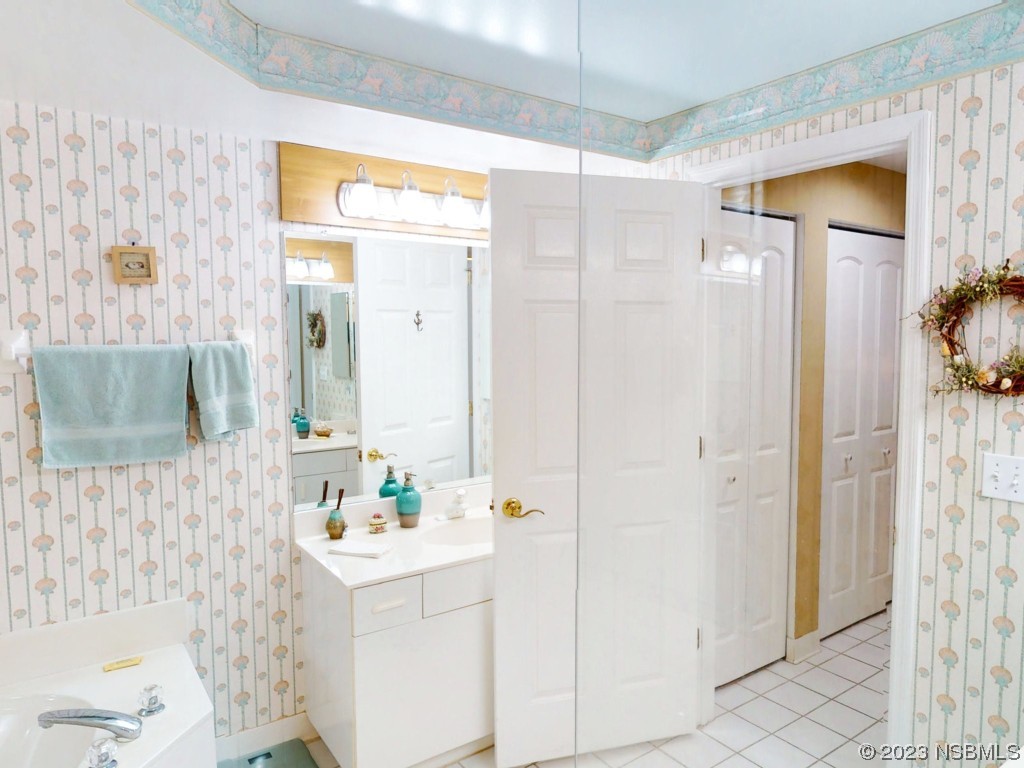 4555 South Atlantic Avenue, Unit 4502 Ponce Inlet, FL 32127 - Photo 31 of 54 a bathroom with a sink and a mirror