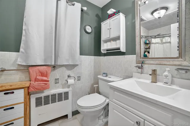 a bathroom with a sink toilet and mirror