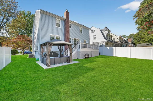 a view of a house with a yard and sitting area