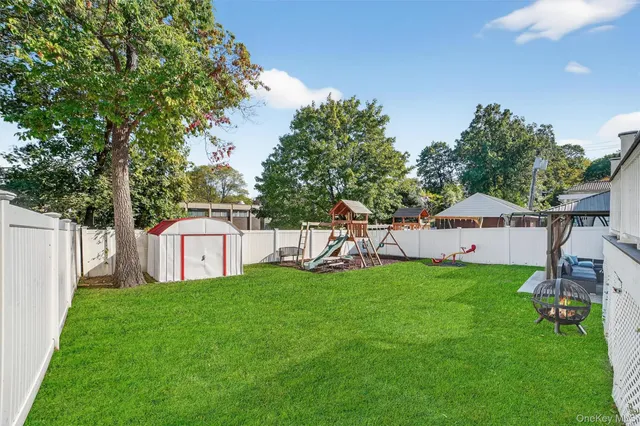 a view of a house with a yard and sitting area