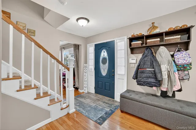 a living room with stairs and a wooden floor