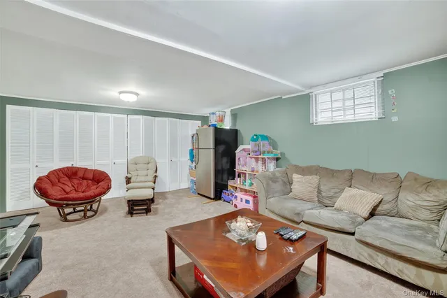 a living room with furniture a rug and a window